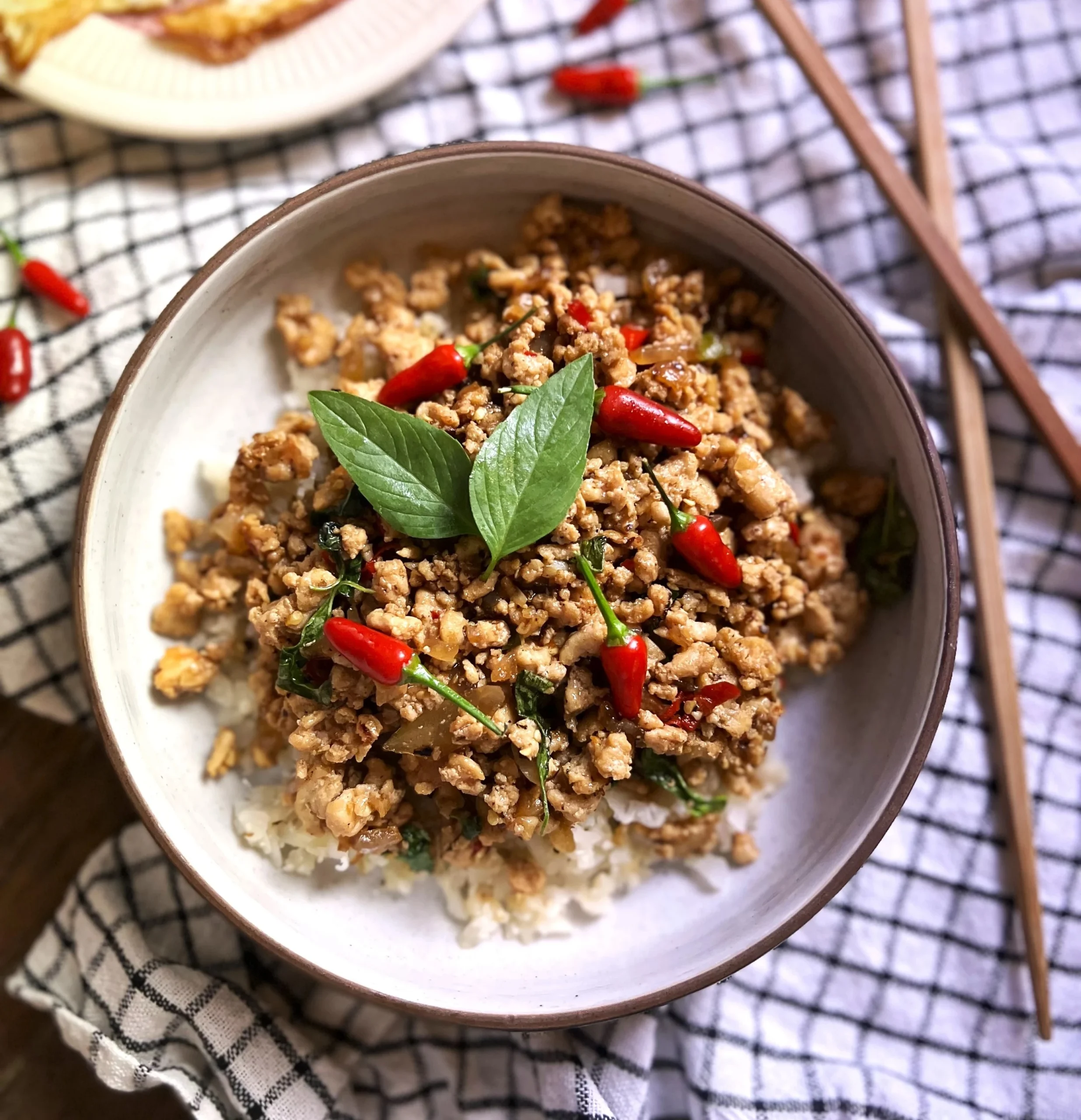 Thai Basil Chicken made with a spicy, savory sauce & sweet Thai basil. Meal prep, low carb & weeknight dinner friendly!