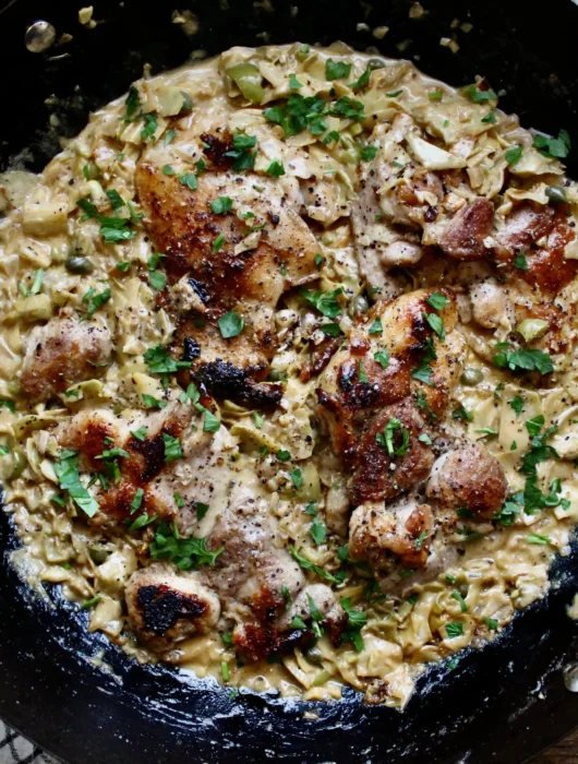 Pan Seared Chicken Thighs with Creamy Artichoke & Olive Sauce. Quick, easy, and a perfect meal for weeknights!