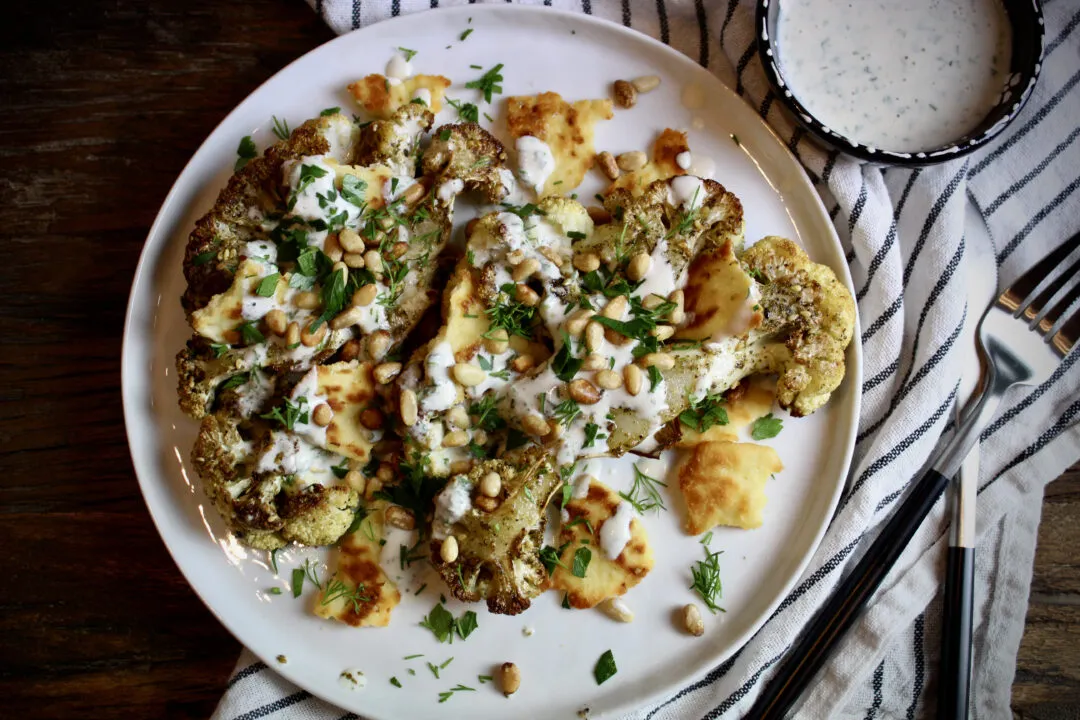 Zataar Roasted Cauliflower topped with Tahini Yogurt Sauce, toasted pine nuts, naan crisps, fresh dill, and parsley. Yum!
